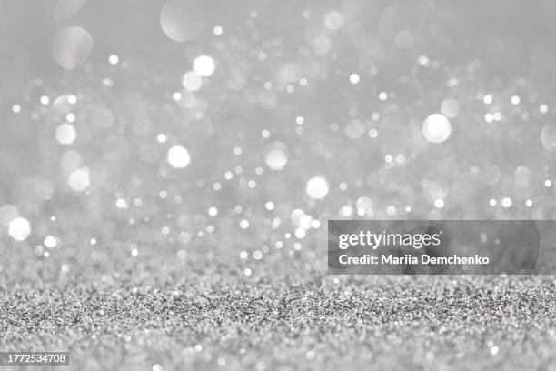 silver sparkling glitter bokeh lights background - silver sparkle stock pictures, royalty-free photos & images