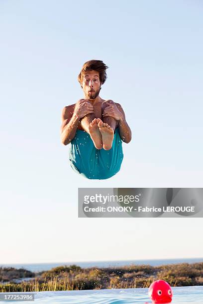 man jumping into a swimming pool - jumping bildbanksfoton och bilder