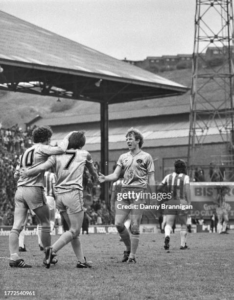 Peter Beardsley of Newcastle United is congratulated by Terry McDermott and David Mills after scoring during a 2-2 draw against Huddersfield Town at...