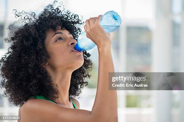 close-up of a woman drinking water from a bottle - woman drinking water from bottle stock-fotos und bilder