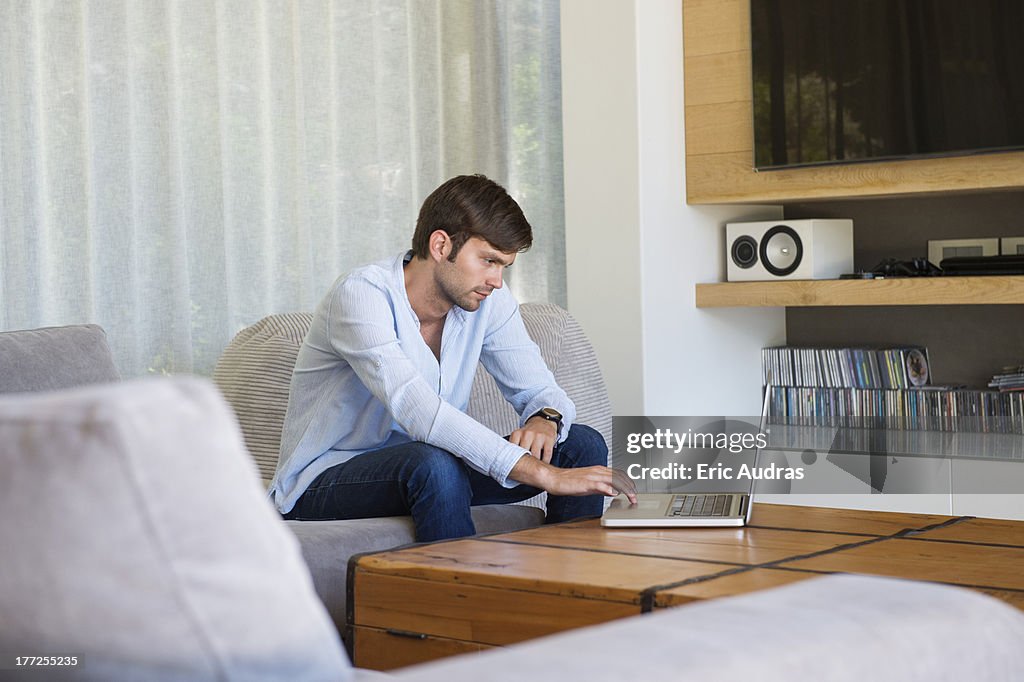 Man using a laptop at home