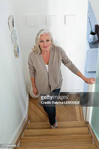 woman moving up on a staircase - hinauf bewegen stock-fotos und bilder