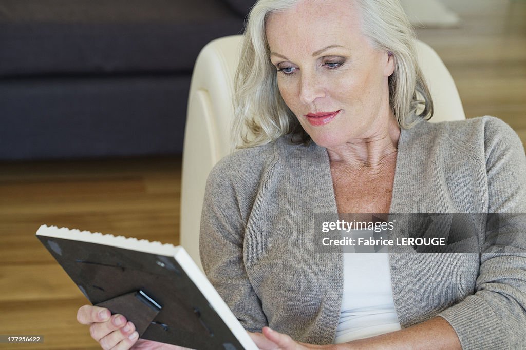 Woman looking at a picture frame