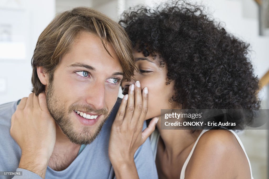 Woman whispering to a man