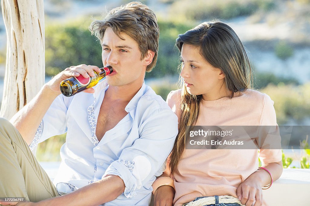 Couple enjoying beer outdoors on a vacation