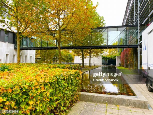 pedestrian bridge between two buildings at odense university hospital, denmark - odense denmark stock pictures, royalty-free photos & images