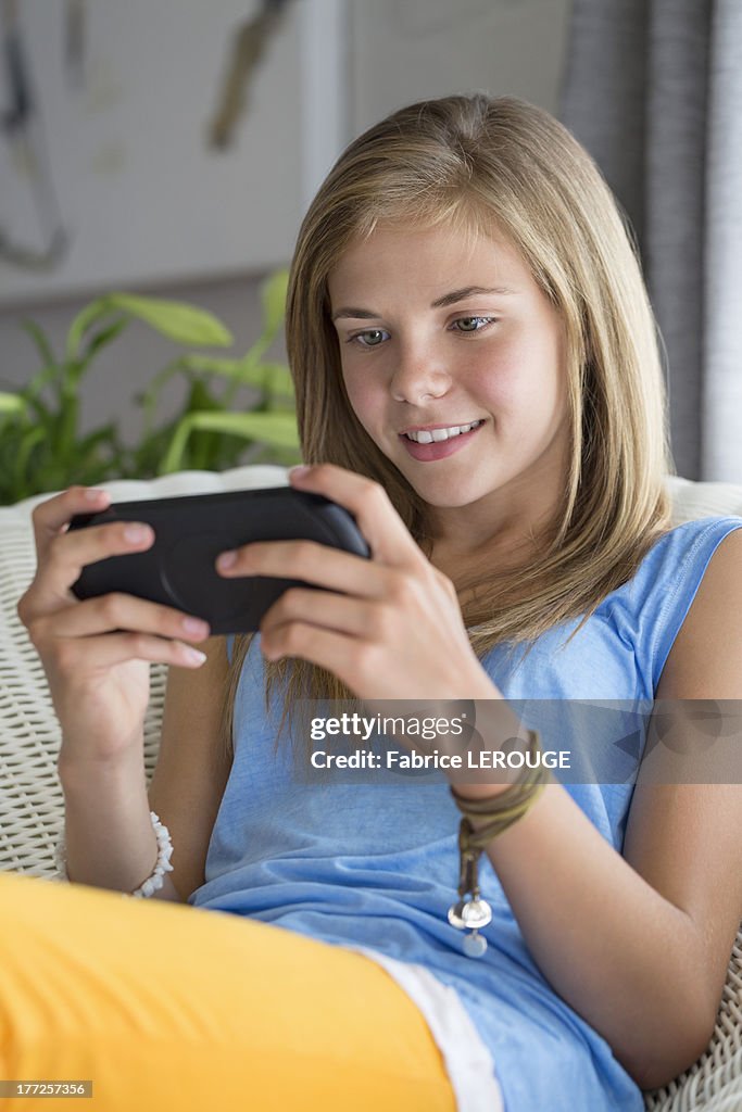 Girl playing a video game and smiling