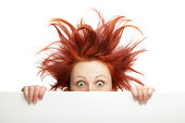 Ginger woman having bad hair day holding a blank board