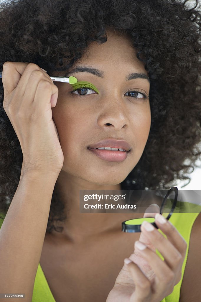 Portrait of a woman applying eyeshadow