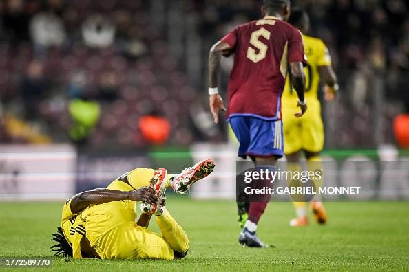 FC Sheriff's Nigerian forward David Ankeye holds his foot as he lays