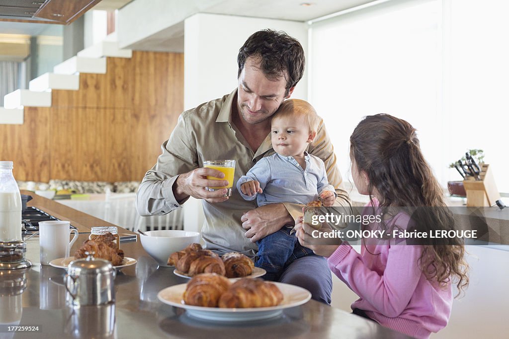 Family having breakfast at a kitchen counter
