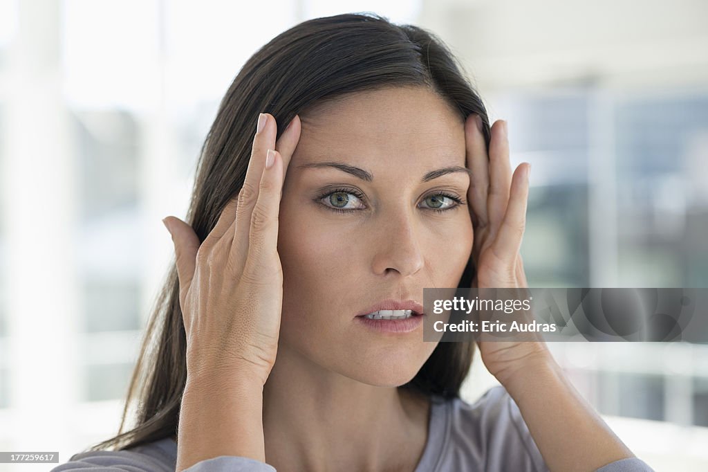 Portrait of a woman suffering from a headache