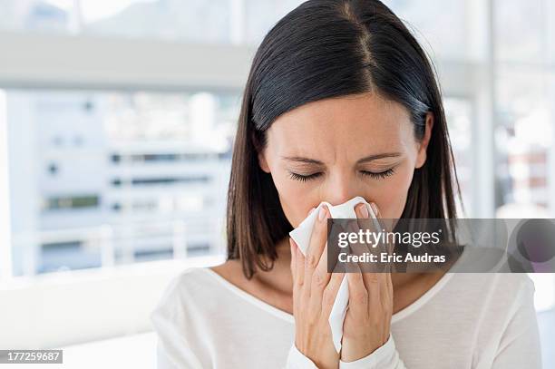 close-up of a woman sneezing - closeup of a hispanic woman sneezing stock pictures, royalty-free photos & images