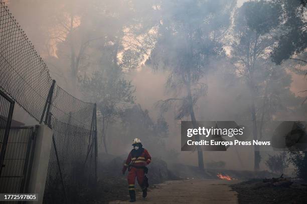 Agent works to extinguish the fire, on November 3 in Ador, Valencia, Valencian Community, Spain. The forest fire declared yesterday, November 2, in...