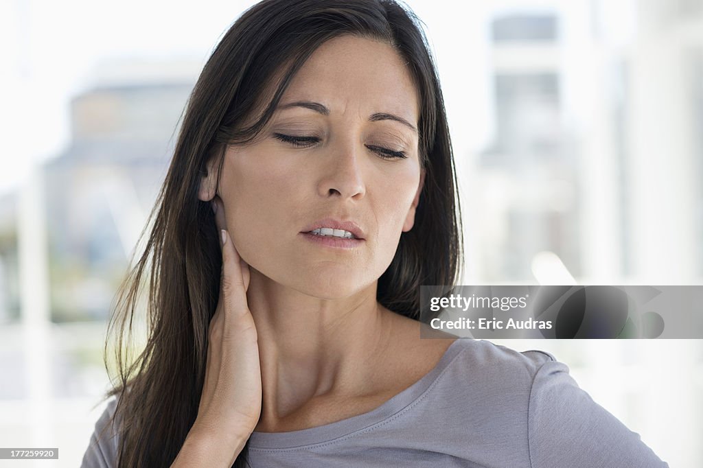 Woman suffering from an neck ache