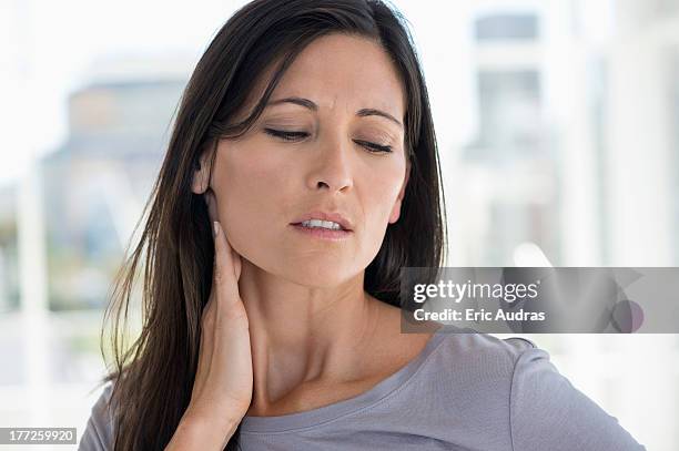 woman suffering from an neck ache - neckache stock pictures, royalty-free photos & images