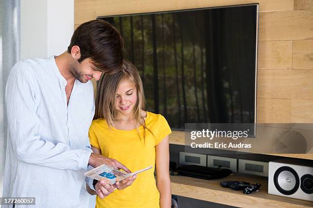 man and his daughter looking at a cd - kids rom stock pictures, royalty-free photos & images