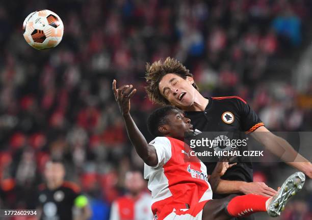 Slavia Prague's Liberia defender Murphy Dorley and Roma's Italian midfielder Edoardo Bove jump for the ball during the UEFA Europa League Group G...