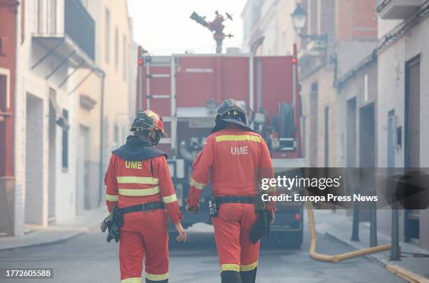 Two UME agents work to extinguish the fire, on November 3 in Ador, Valencia, Valencian Community, Spain. The forest fire declared yesterday, November...