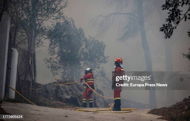 Two UME agents work to extinguish the fire, on November 3 in Ador, Valencia, Valencian Community, Spain. The forest fire declared yesterday, November...