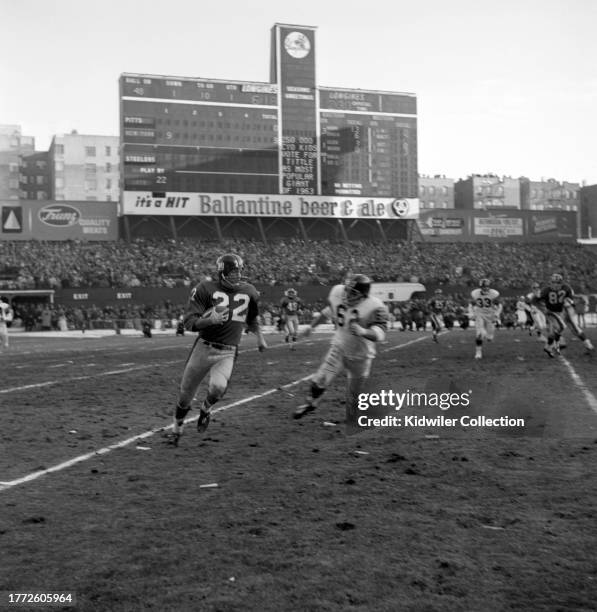 Dick Lynch of the New York Giants returns an interception against Mike Sandusky of the Pittsburgh Steelers during a game at Yankee Stadium on...