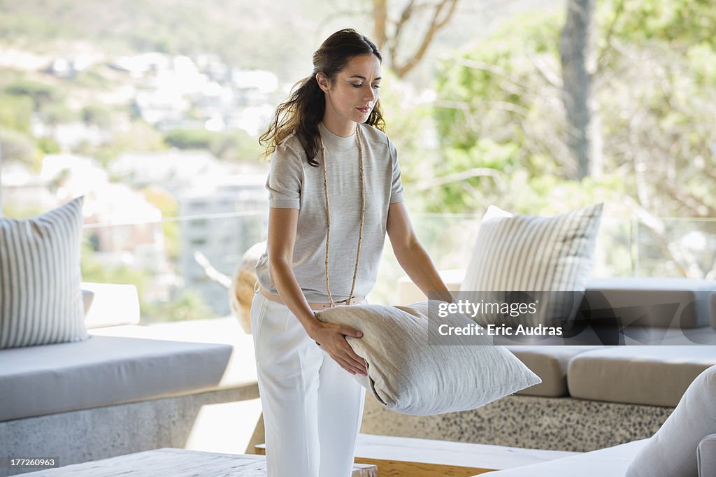 Woman holding a pillow at home
