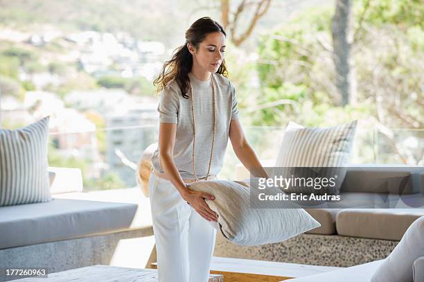 woman holding a pillow at home - cushion imagens e fotografias de stock