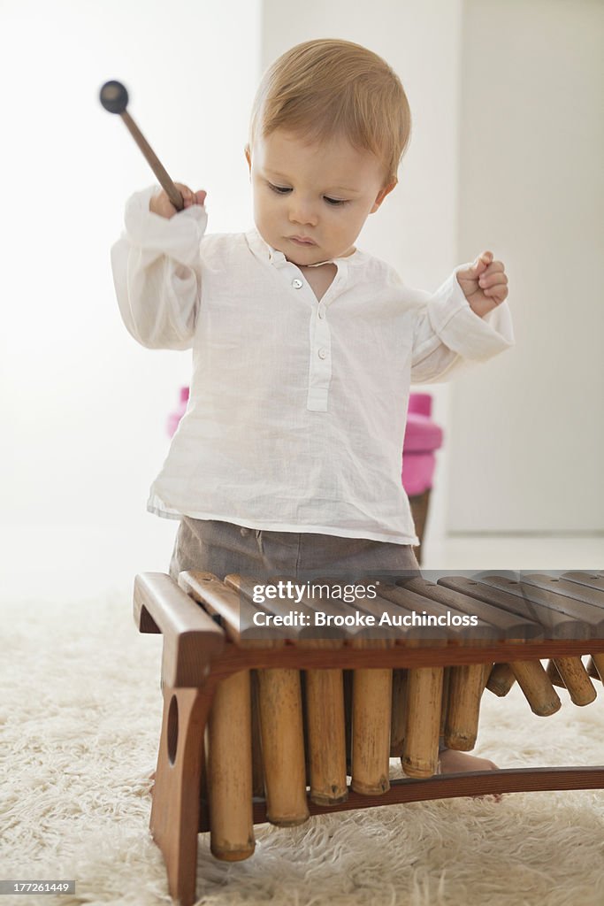 Baby boy playing a xylophone