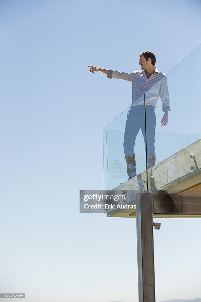 Man standing on the terrace and pointing