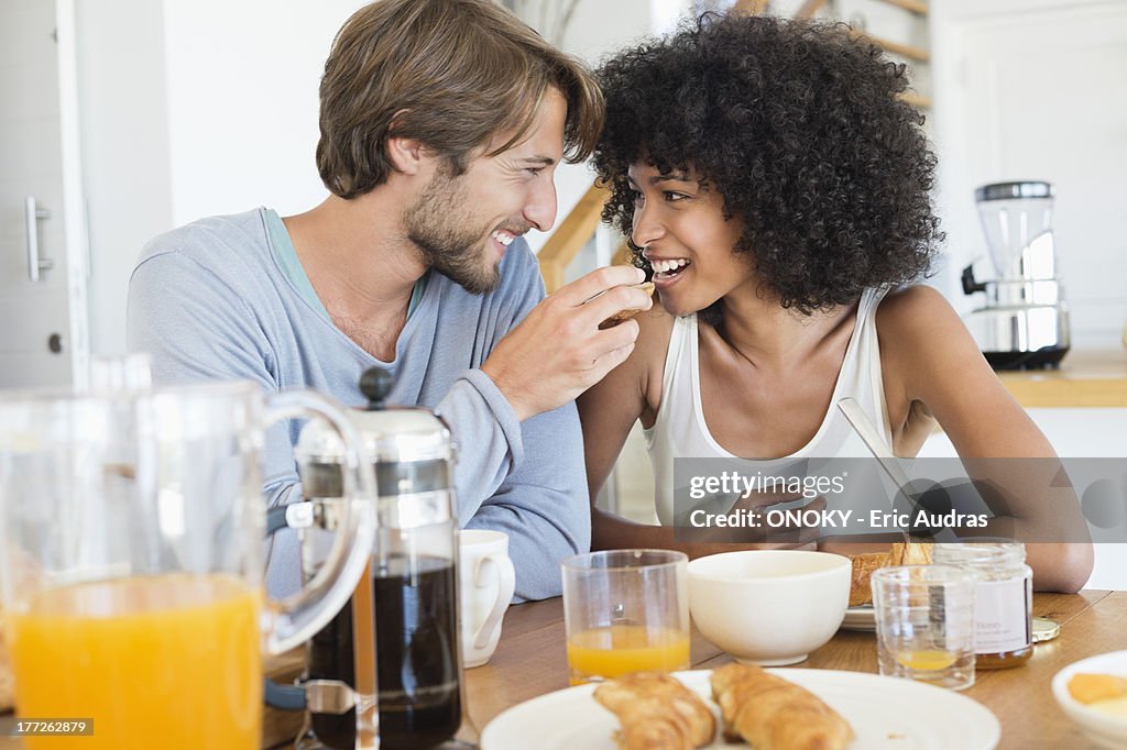 Man feeding food to her wife