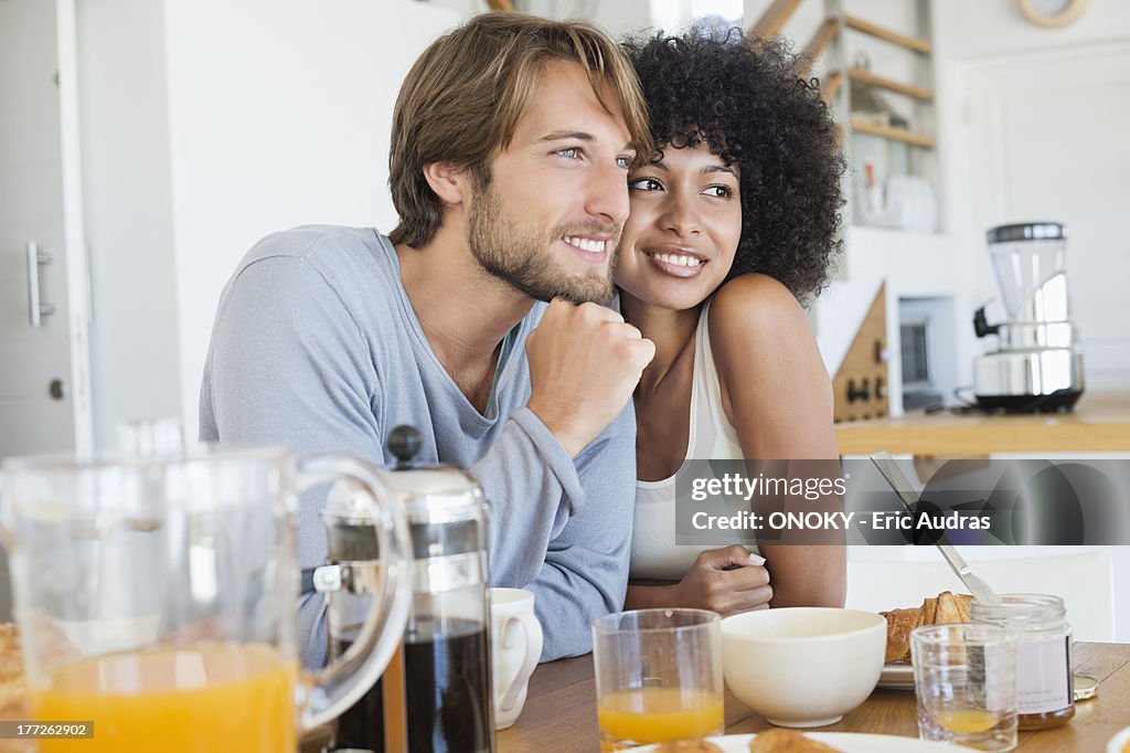 Smiling couple sitting at a dining table
