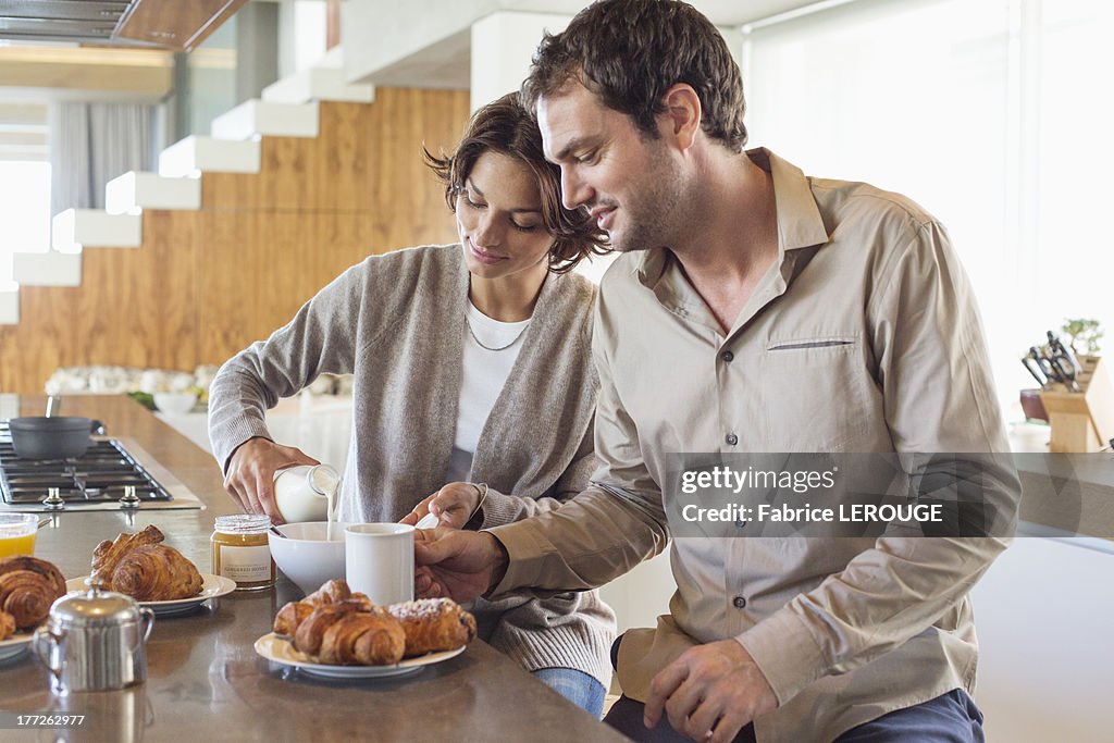 Couple having breakfast at a kitchen counter