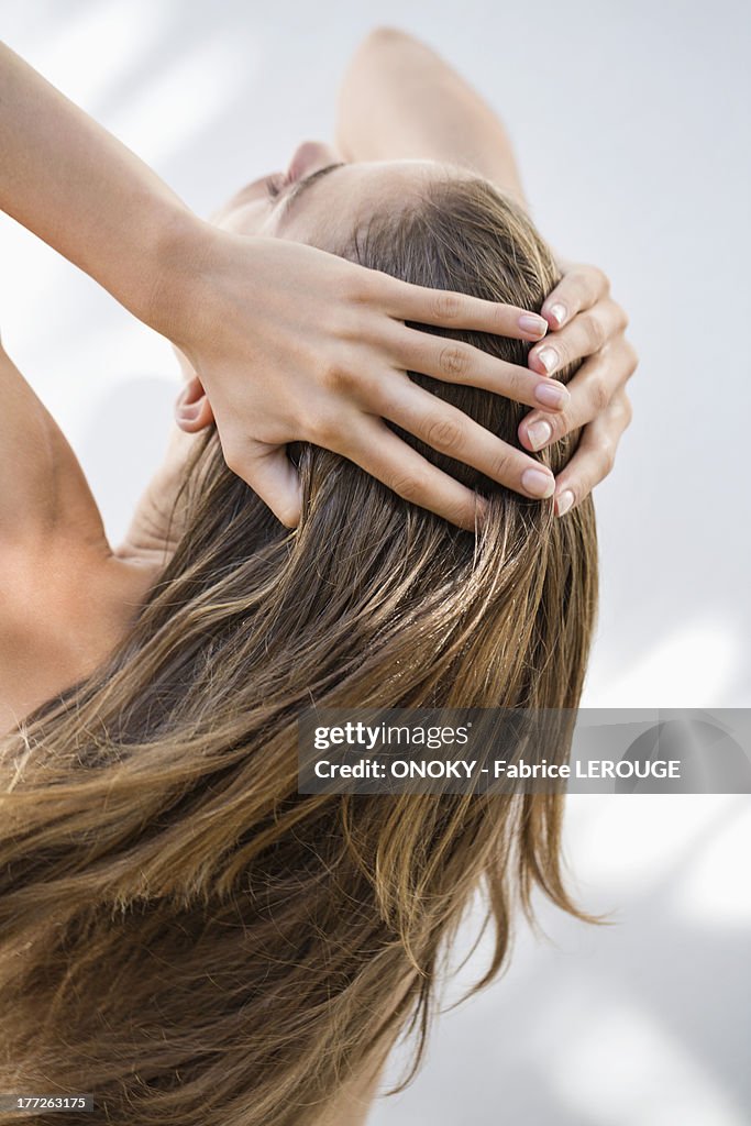 Close-up of a woman holding her hair
