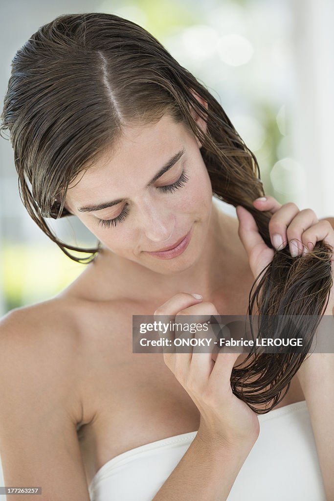 Woman applying conditioner in her hair