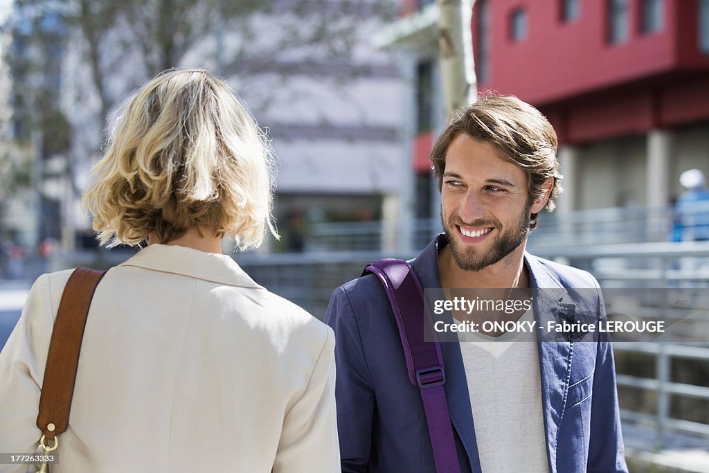 Man flirting a woman and smiling