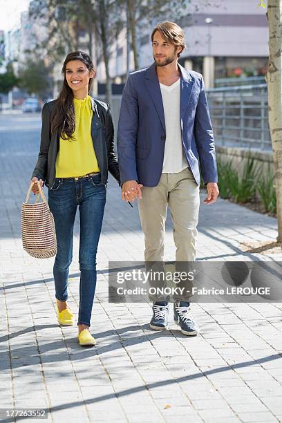 happy couple walking on a street - young couple holding hands stock pictures, royalty-free photos & images