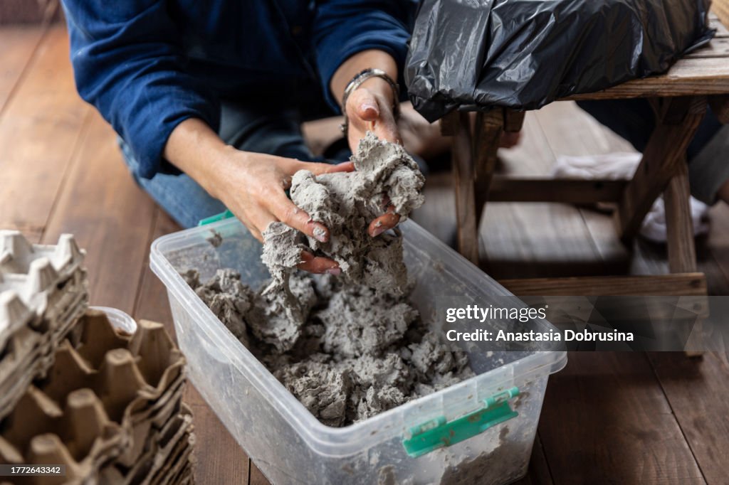 Close up female hands molding clay