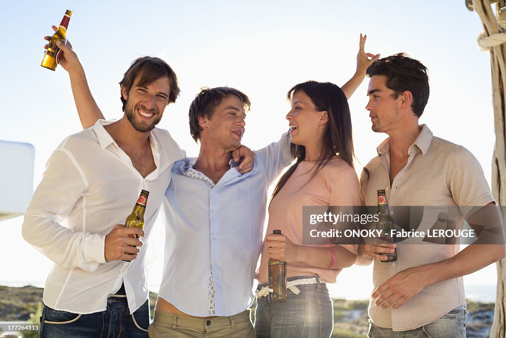 Four friends drinking beer