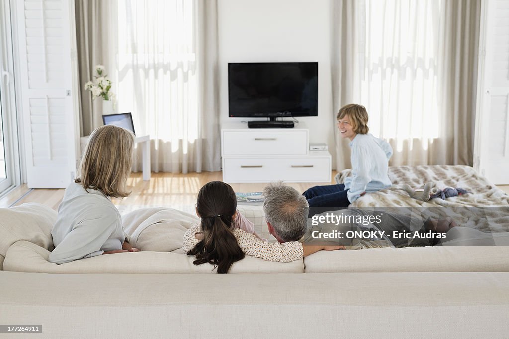 Family watching television together