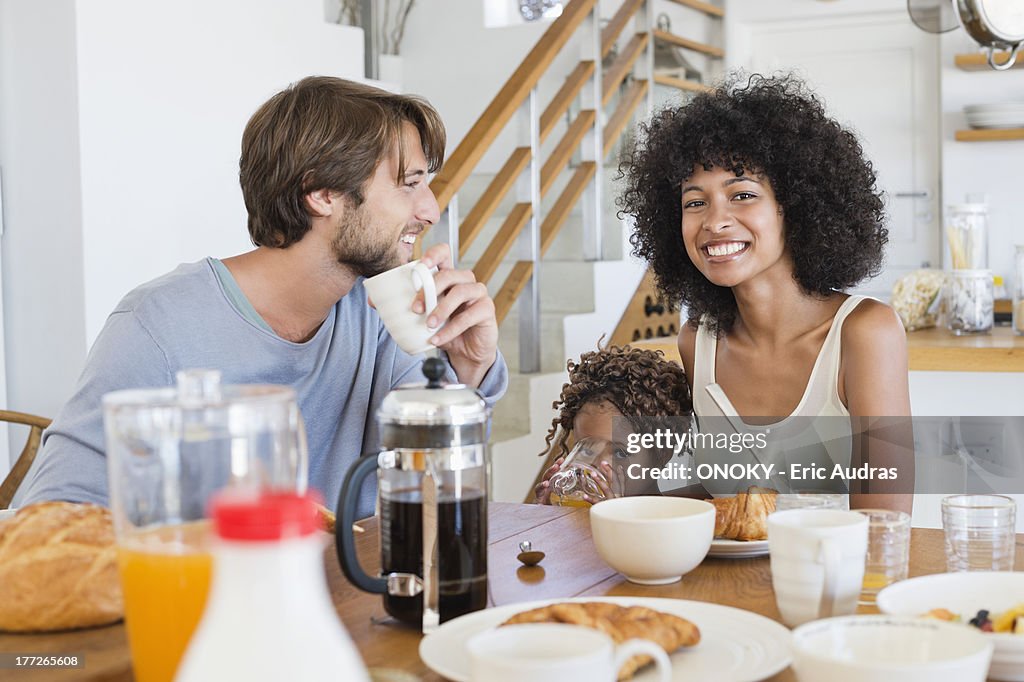 Parents with their daughter at a dining table