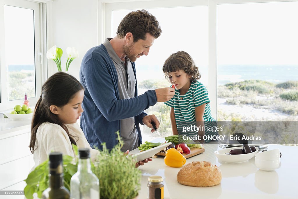 Man preparing food for his children