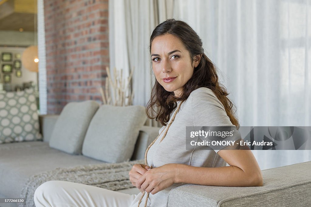 Portrait of a beautiful woman sitting on a couch