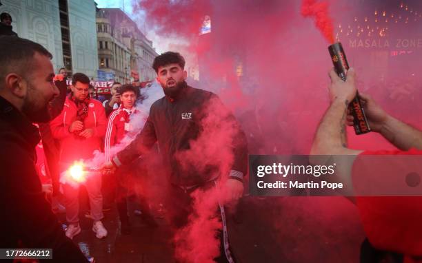 Fans chant and sing in a smoke laden atmosphere during a pre-match celebration at Piccadilly Circus on November 9, 2023 in London, England....