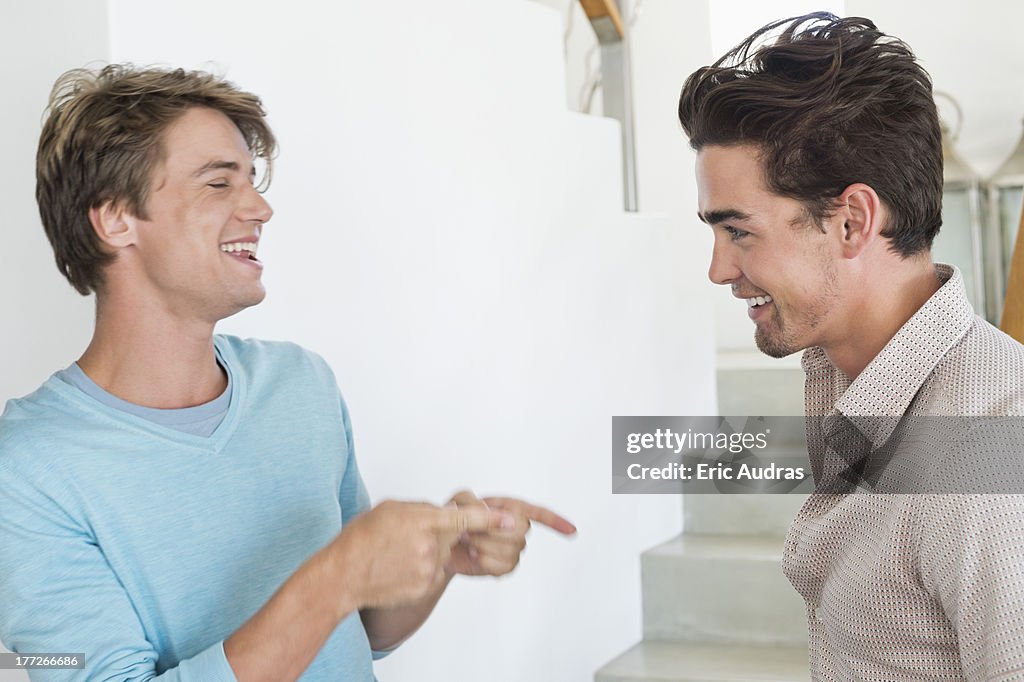 Two male friends talking to each other