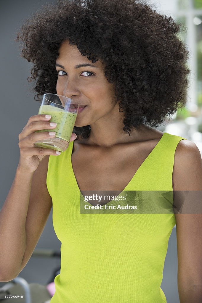 Portrait of a woman drinking kiwi shake