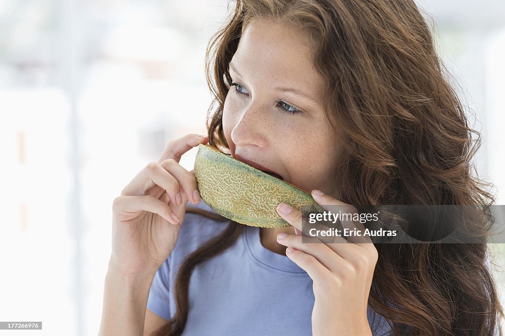 Close-up of a woman eating melon