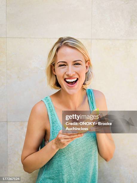 smiling woman eating melon - blond women happy eating stock pictures, royalty-free photos & images