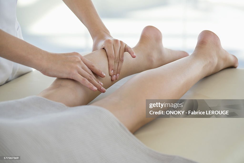 Woman receiving leg massage from a massage therapist