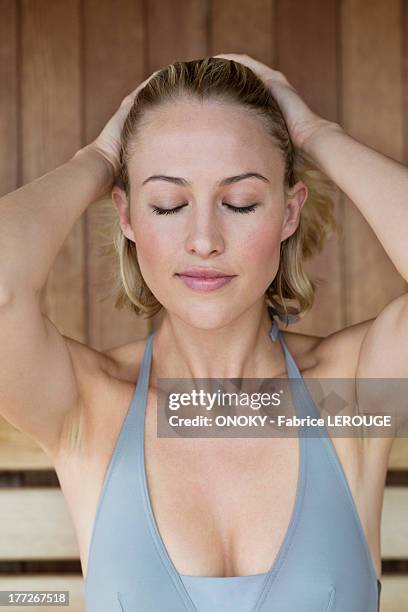 close-up of a beautiful woman in a sauna - dekolleté stock-fotos und bilder