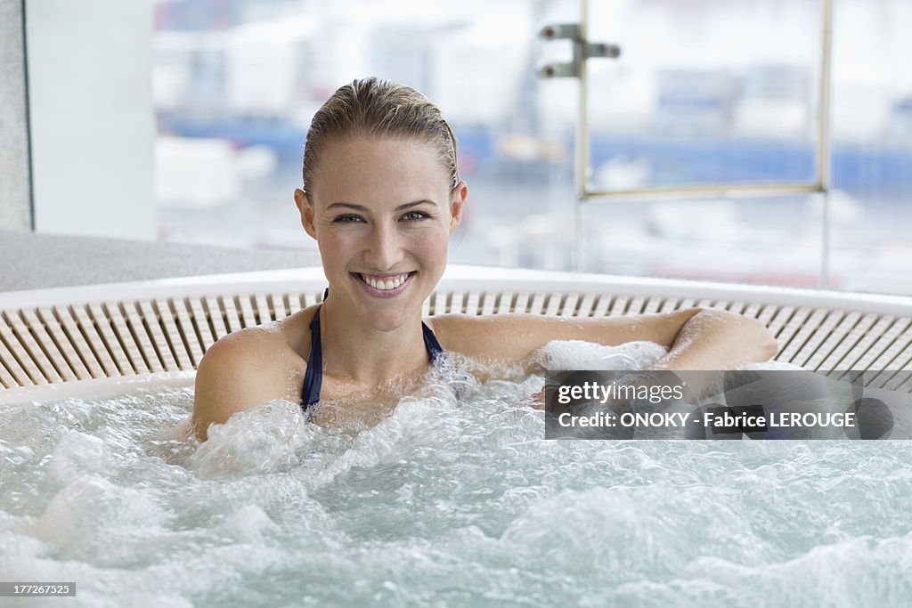 Portrait of a smiling beautiful woman in a hot tub